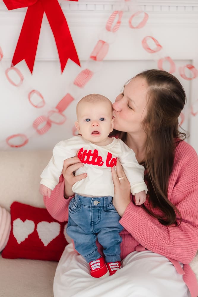 mom kissing baby during valentine's themed 3 month milestone photography session in knoxville tn
