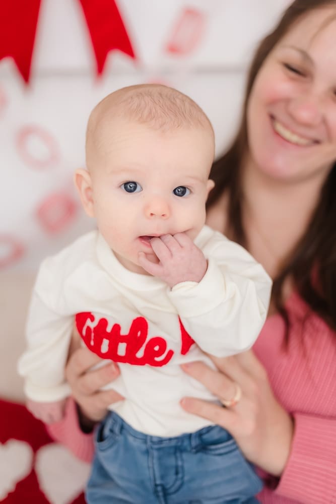 baby chewing on fingers during valentine's themed 3 month milestone photography session in knoxville tn