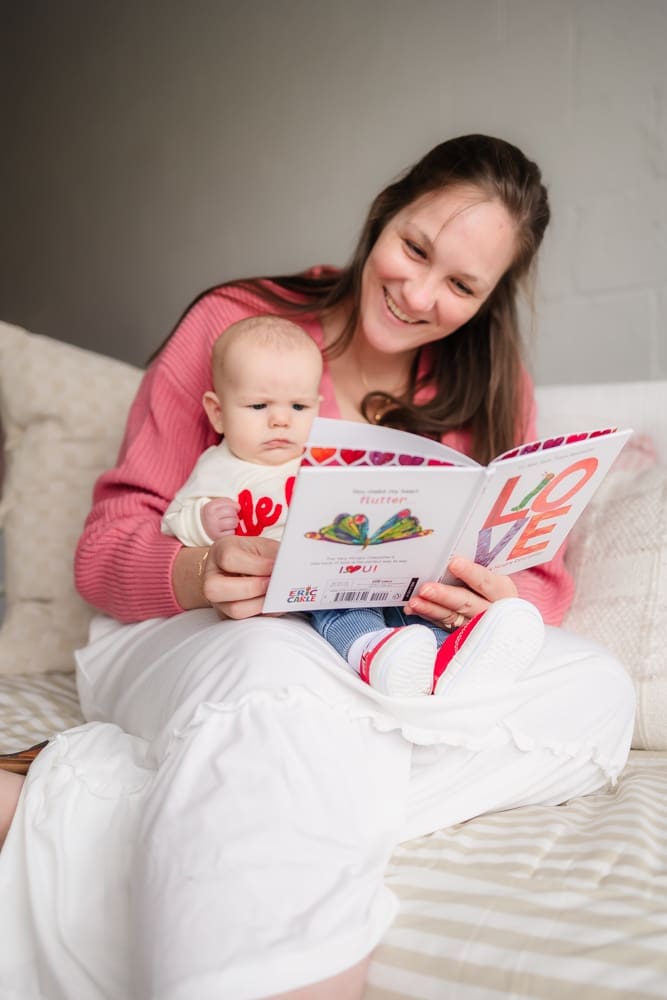 mom reading to baby during valentine's themed 3 month milestone photography session in knoxville tn