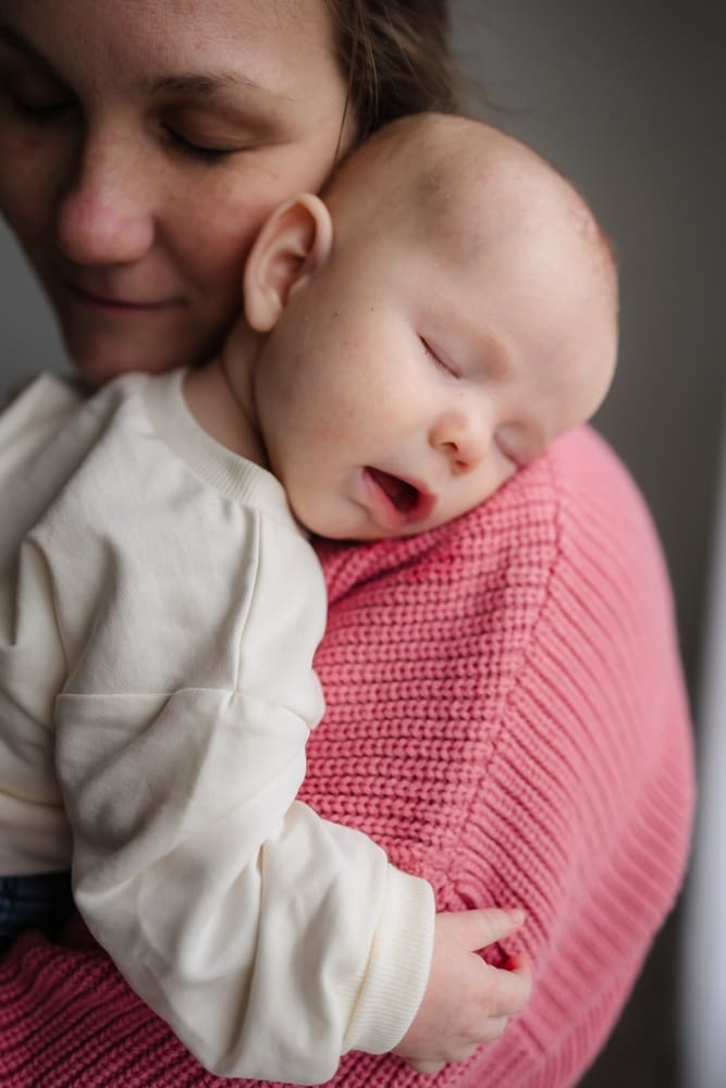baby sleeping on mom's shoulder during valentine's themed 3 month milestone photography session in knoxville tn