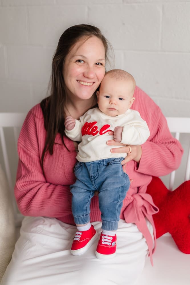 mom smiling with baby during valentine's themed 3 month milestone photography session in knoxville tn