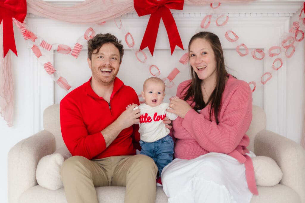 mom and dad smiling with baby during valentine's themed 3 month milestone photography session in knoxville tn