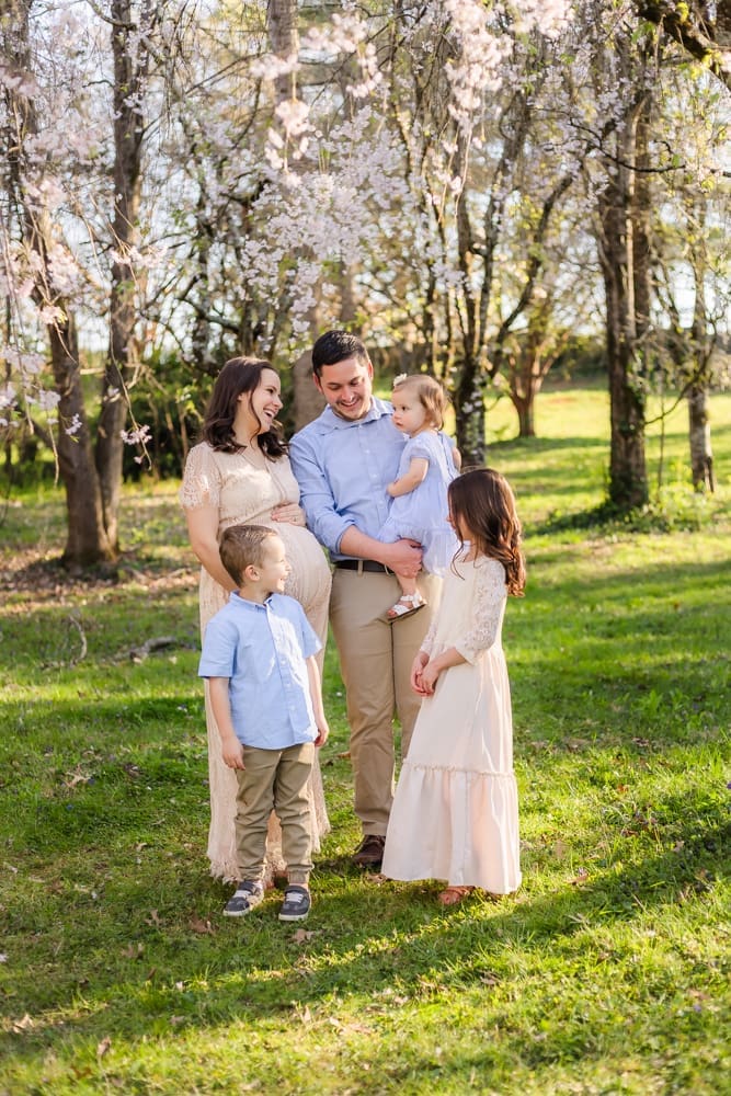 spring family smiles during maternity photography session in knoxville tn