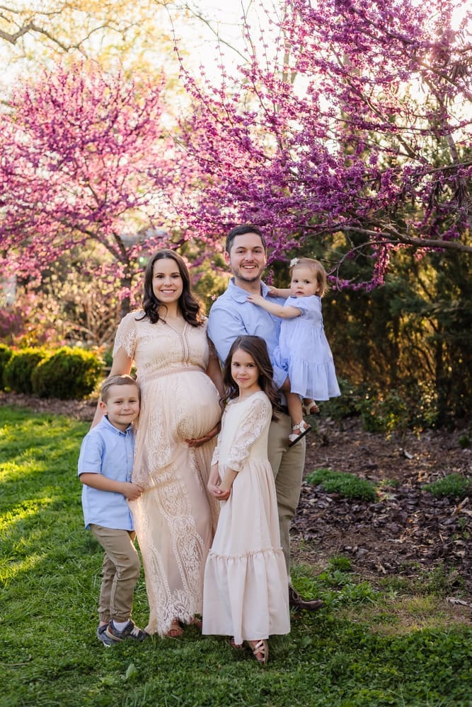 family smiling together during maternity photography session in knoxville tn