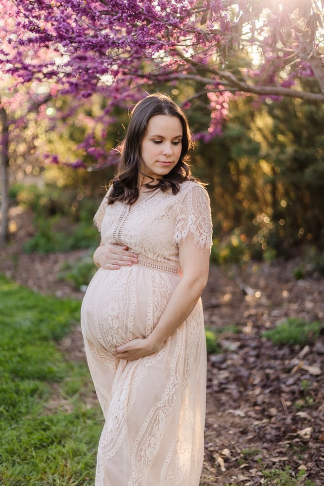 mom cradling baby bump during maternity photography session in knoxville tn