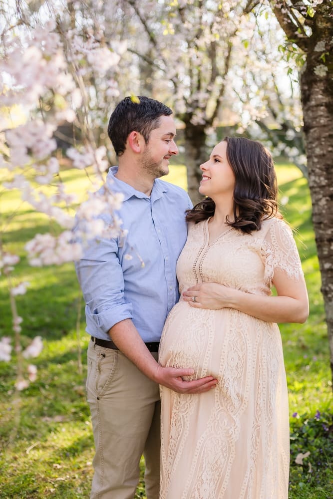 mom and dad looking at each other during maternity photography session in knoxville tn