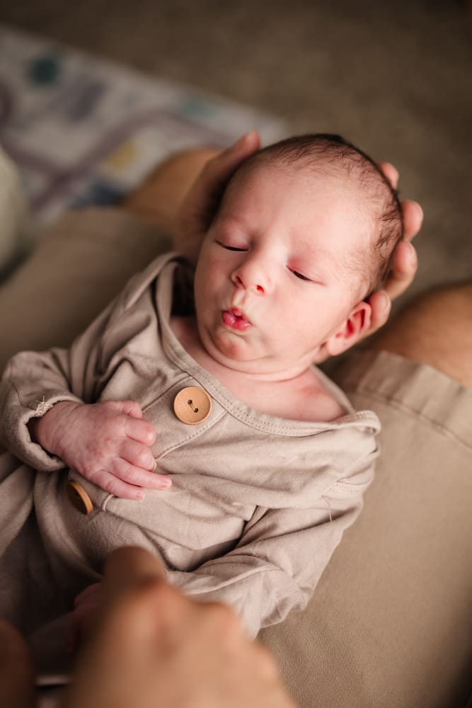 newborn making funny face during in home lifestyle newborn photography session in knoxville tn