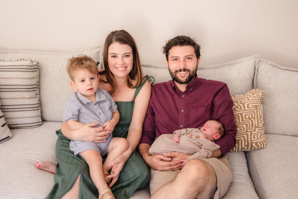 family on couch during in home lifestyle newborn photography session in knoxville tn