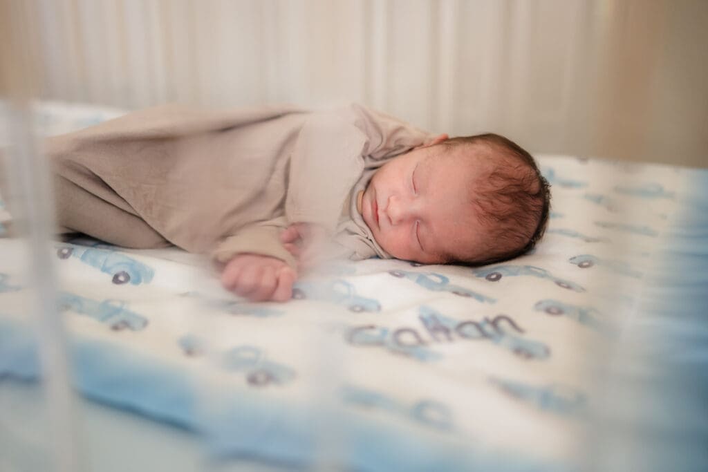 newborn laying in crib during in home lifestyle newborn photography session in knoxville tn