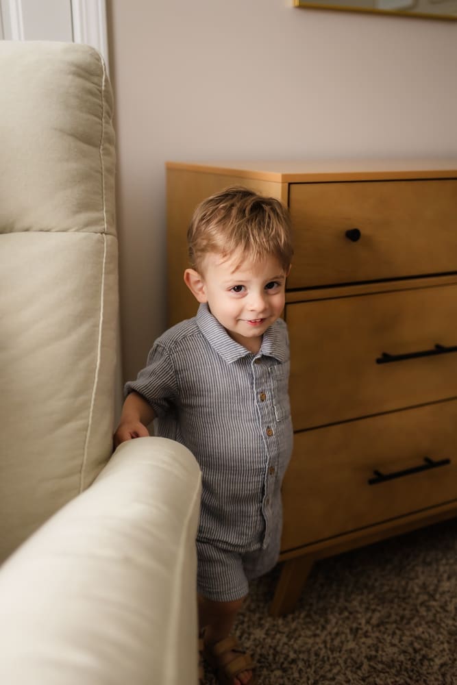 older brother smiling during in home lifestyle newborn photography session in knoxville tn
