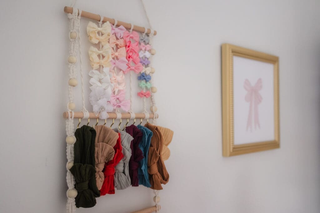 bow rack nursery details during in-home lifestyle newborn session by knoxville newborn and maternity photographer Kelsey Wood Portraits.