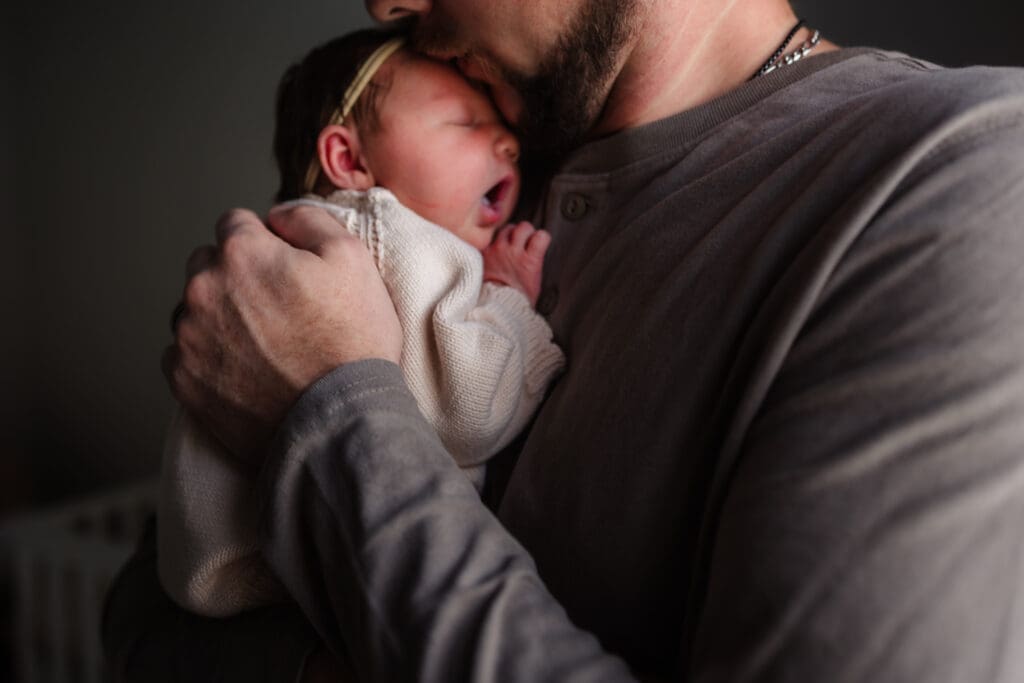 newborn yawning on dads chest during in-home lifestyle newborn session by knoxville newborn and maternity photographer Kelsey Wood Portraits.