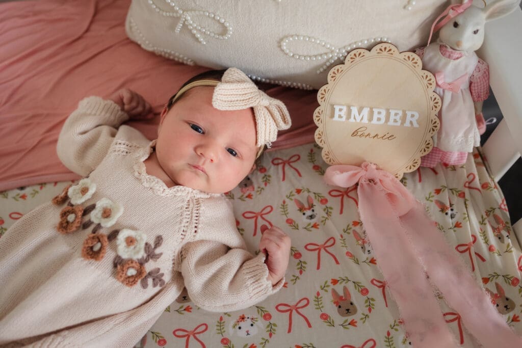 newborn laying in bow and bunny crib during in-home lifestyle newborn session by knoxville newborn and maternity photographer Kelsey Wood Portraits.