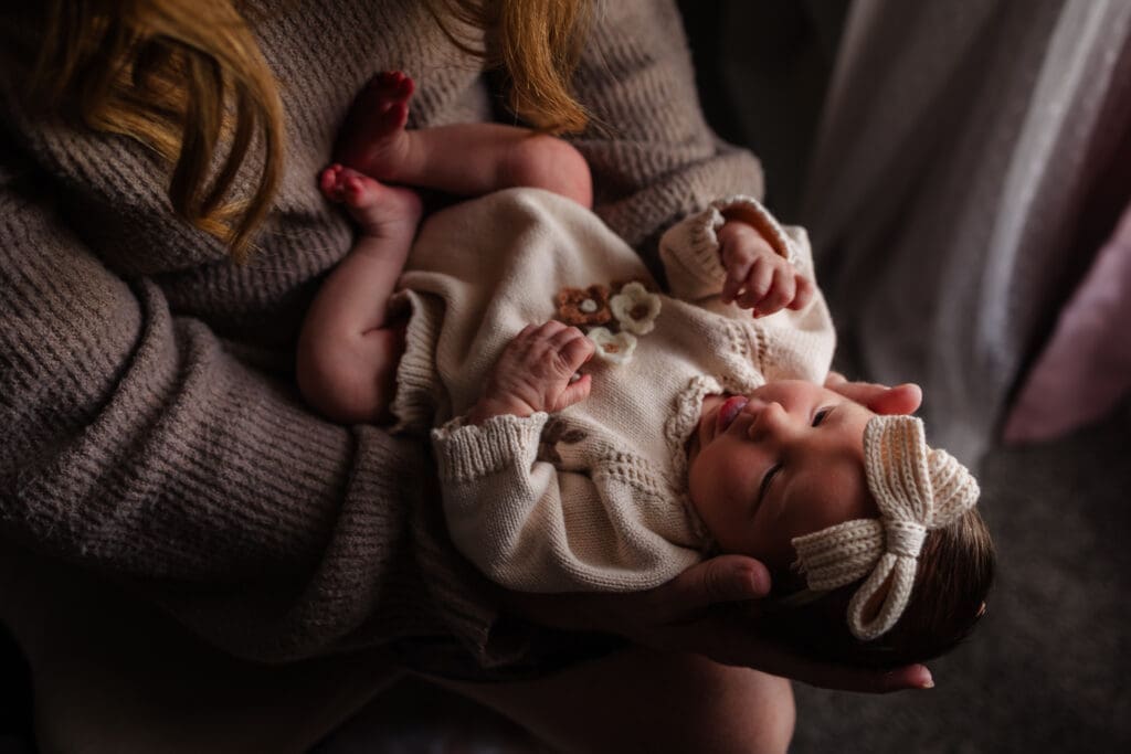 newborn snuggling with mom during in-home lifestyle newborn session by knoxville newborn and maternity photographer Kelsey Wood Portraits.