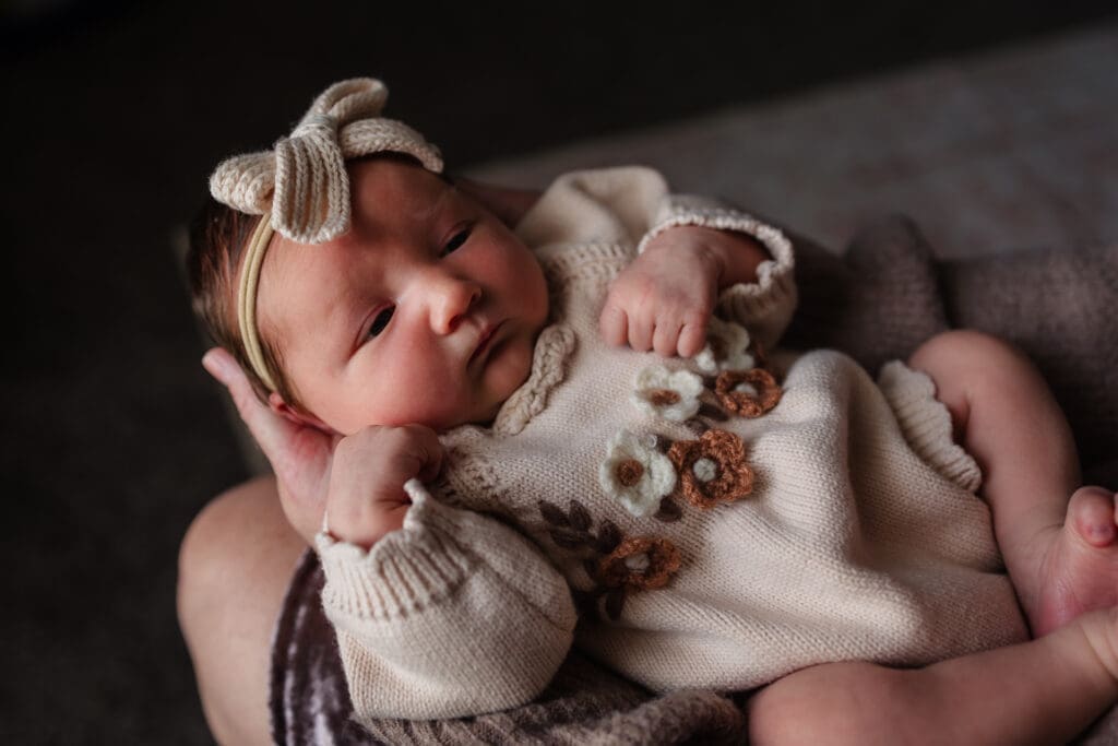 newborn looking up at mom during in-home lifestyle newborn session by knoxville newborn and maternity photographer Kelsey Wood Portraits.