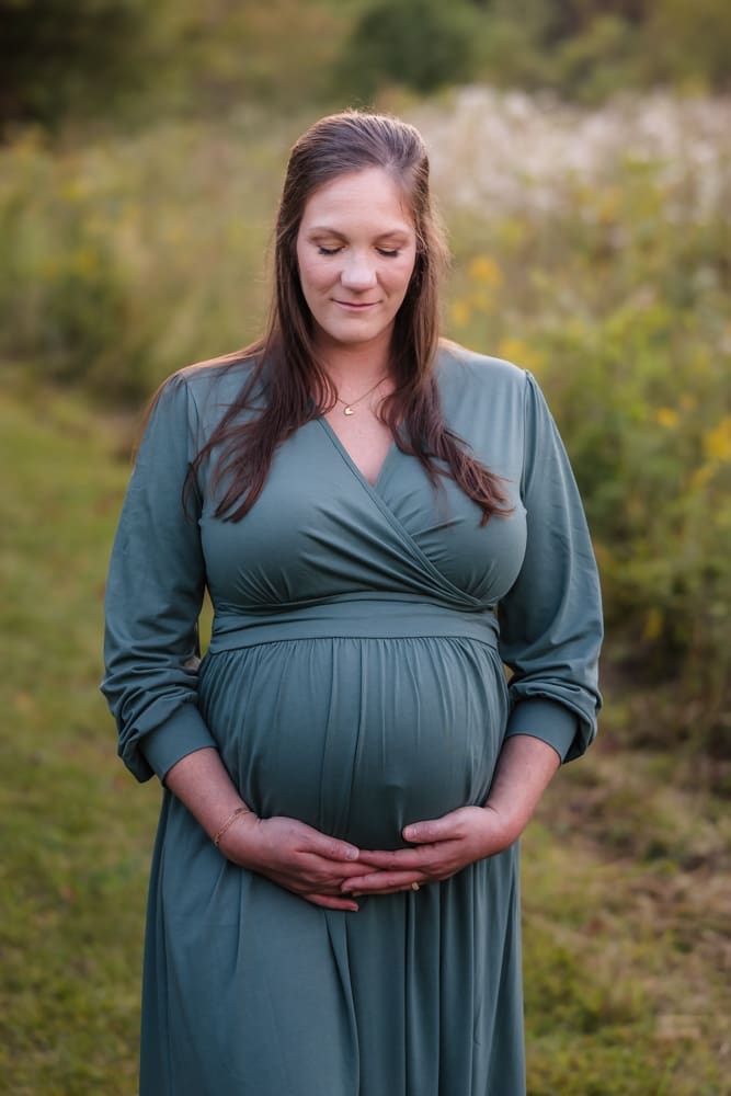 expecting mom taking a moment to soak in her pregnancy during knoxville maternity photo shoot at seven isalnds park in kodak