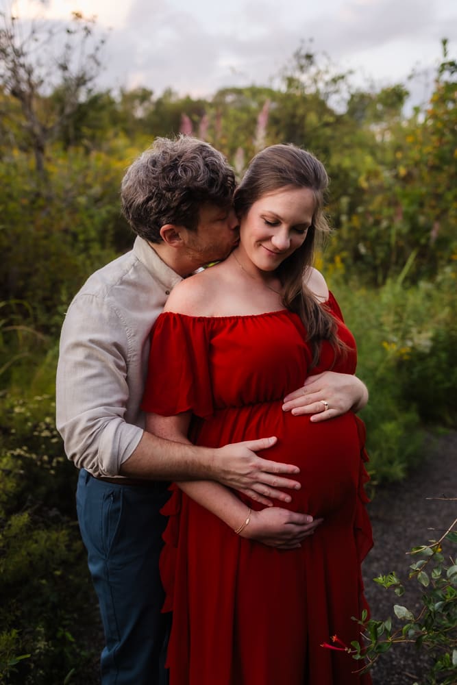 expecting parents snuggling during knoxville maternity photo shoot at seven isalnds park in kodak