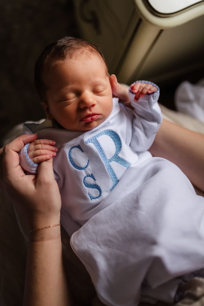 newborn on moms lap during in-home lifestyle newborn photography session in knoxville tn