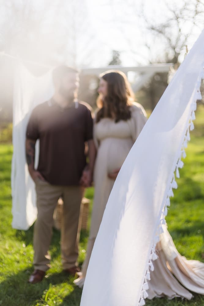 mom and dad looking at each other during knoxville maternity photography session at the Holmstead studio