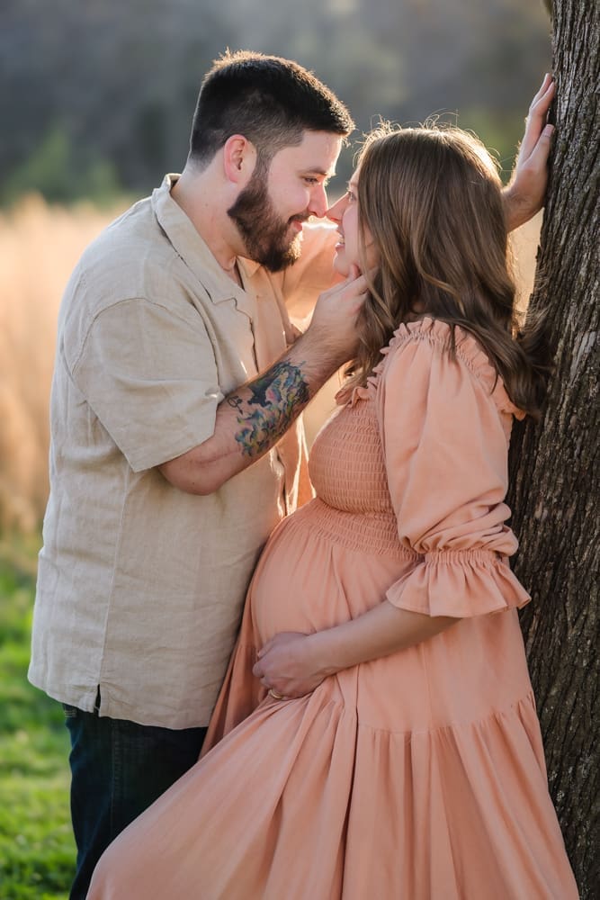 mom and dad almost kissing during knoxville maternity photography session at the Holmstead studio