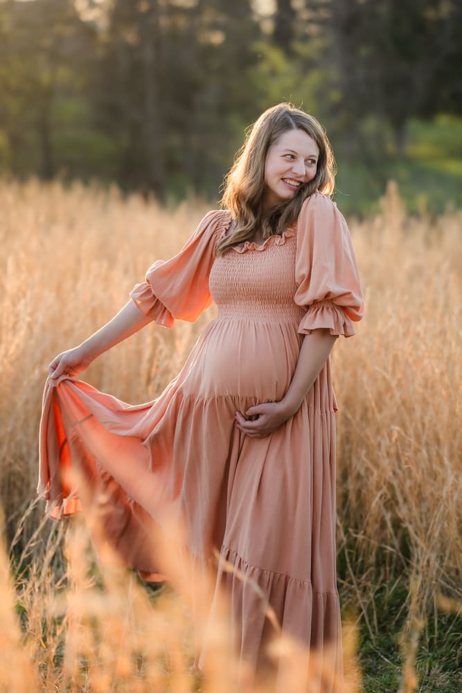 mom twirling dress during knoxville maternity photography session at the Holmstead studio