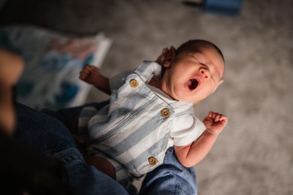 baby boy yawning during knoxville in-home lifestyle newborn photography session