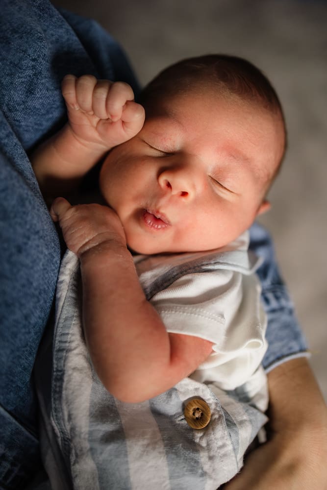 baby boy making funny face while sleeping during knoxville in-home lifestyle newborn photography session