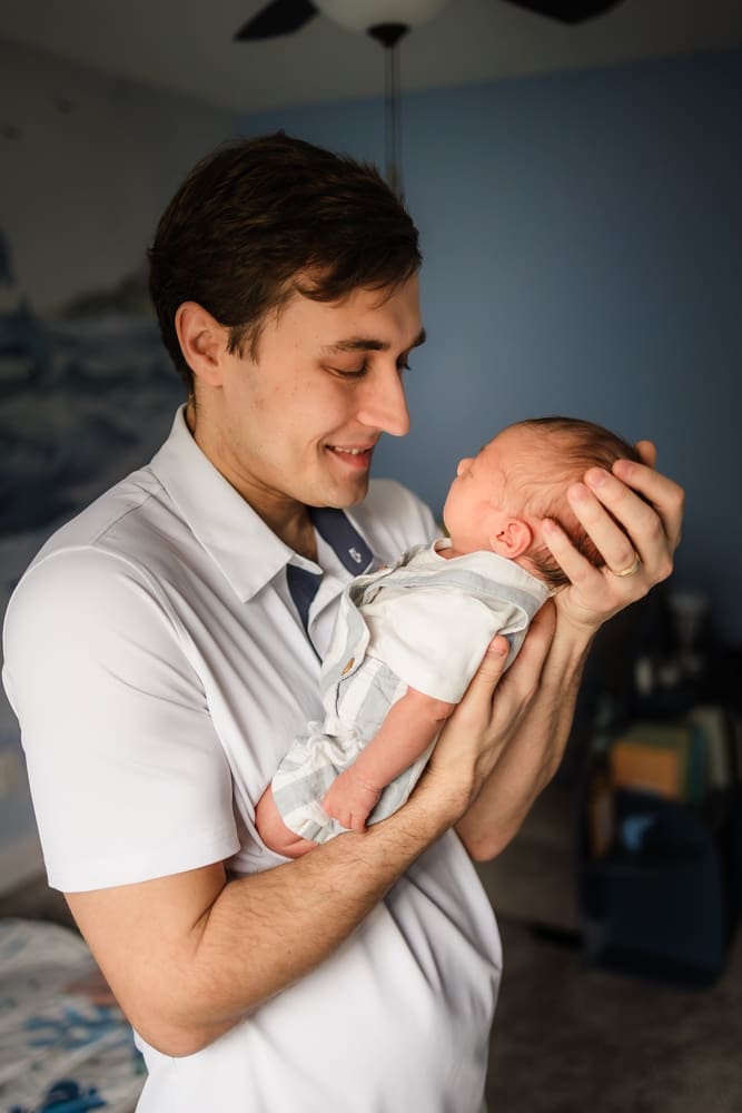dad admires newborn son during knoxville in-home lifestyle newborn photography session