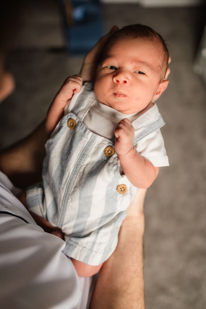 baby boy making funny face during knoxville in-home lifestyle newborn photography session