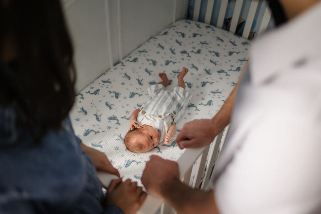 baby laying in crib looking from mom and dad's perpective
