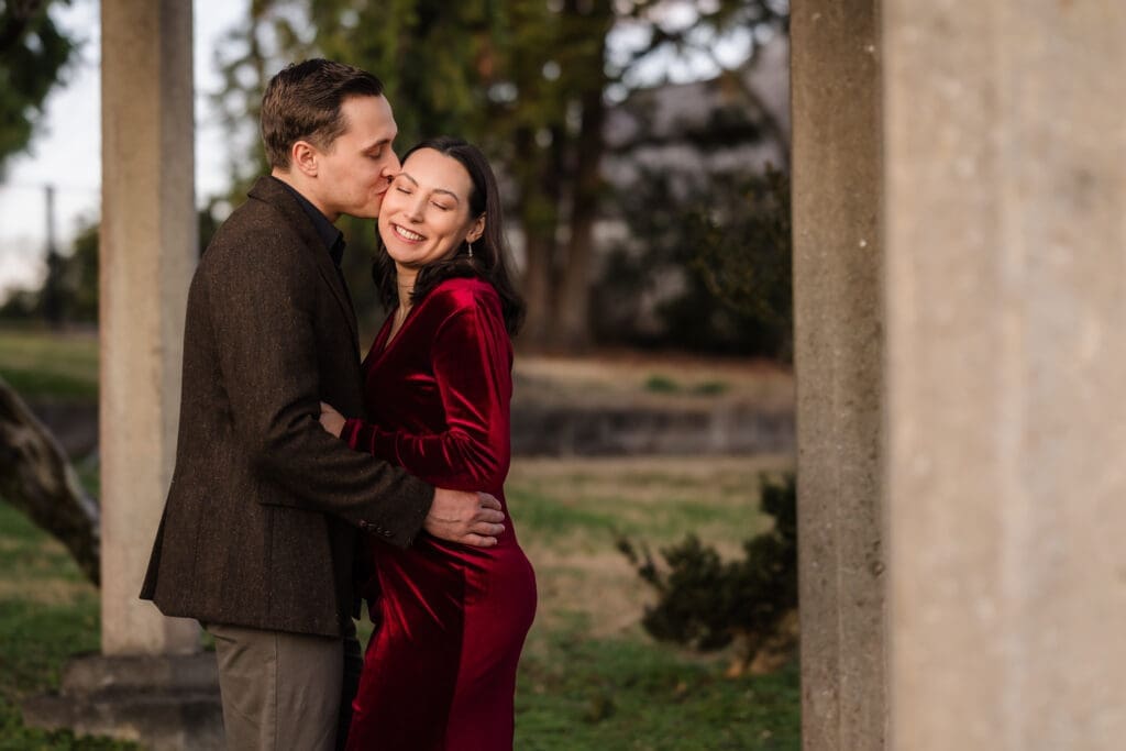 couple snuggling during maternity session in the grounds of the bleak house