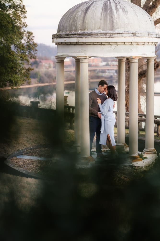 expecting couple sharing a moment under a gazebo during knoxville maternity photography session at the bleak house