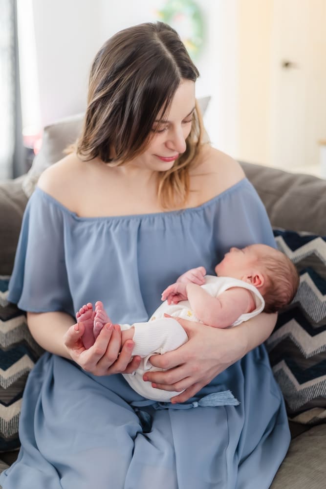 mom holding newborn during newborn photo shoot in west knoxville home