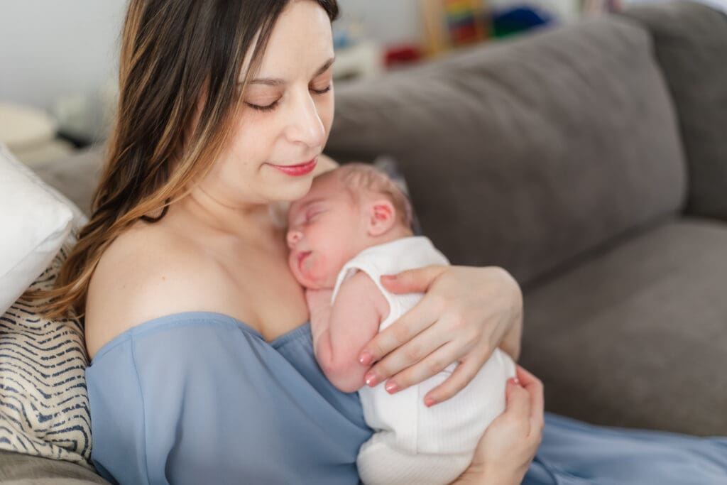 baby boy rests on mom's chest during in home lifestyle newborn session
