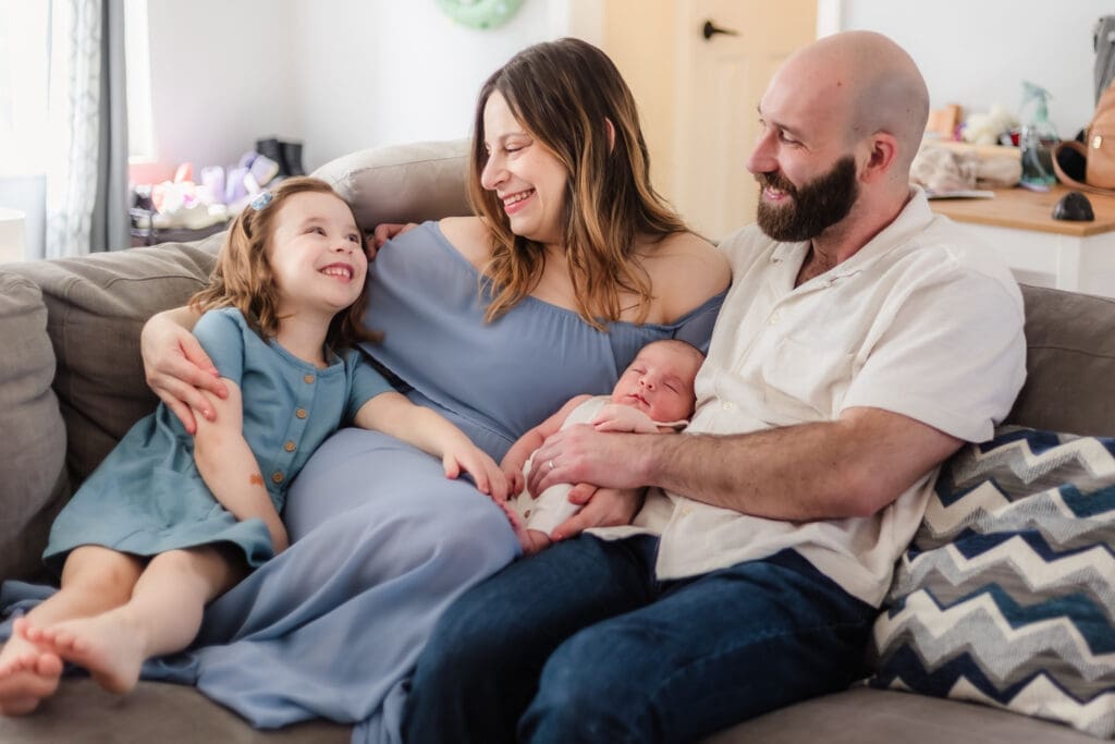 family smiling at big sister during knoxville newborn session