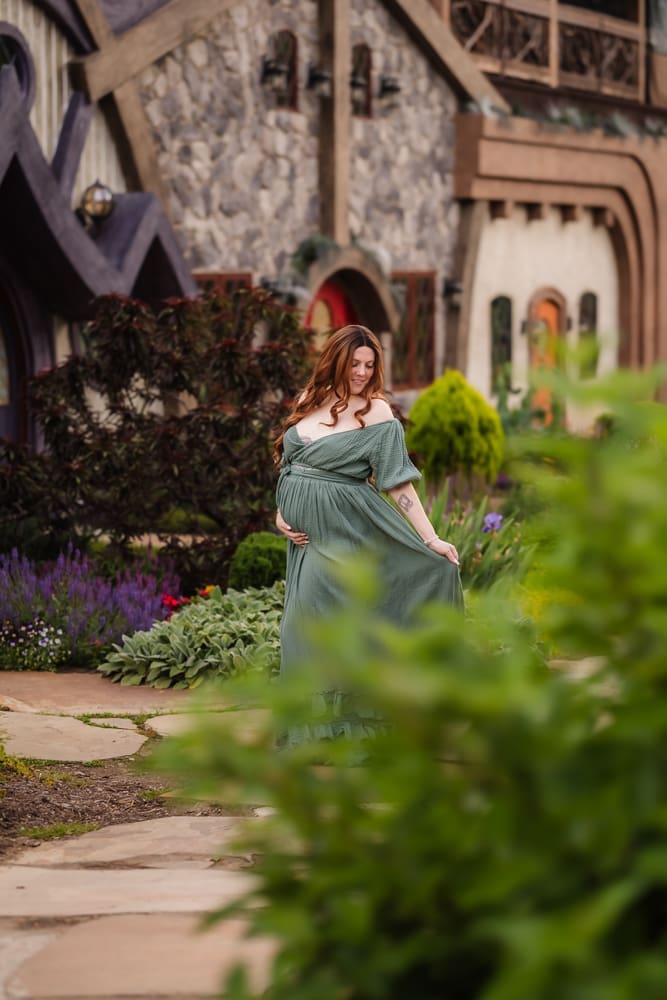 mom twirling dress during fantasy inspired knoxville maternity photography session at ancient lore village