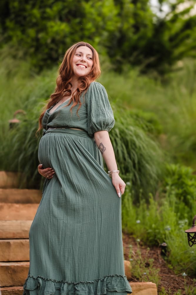 mom standing on stairs during fantasy inspired knoxville maternity photography session at ancient lore village