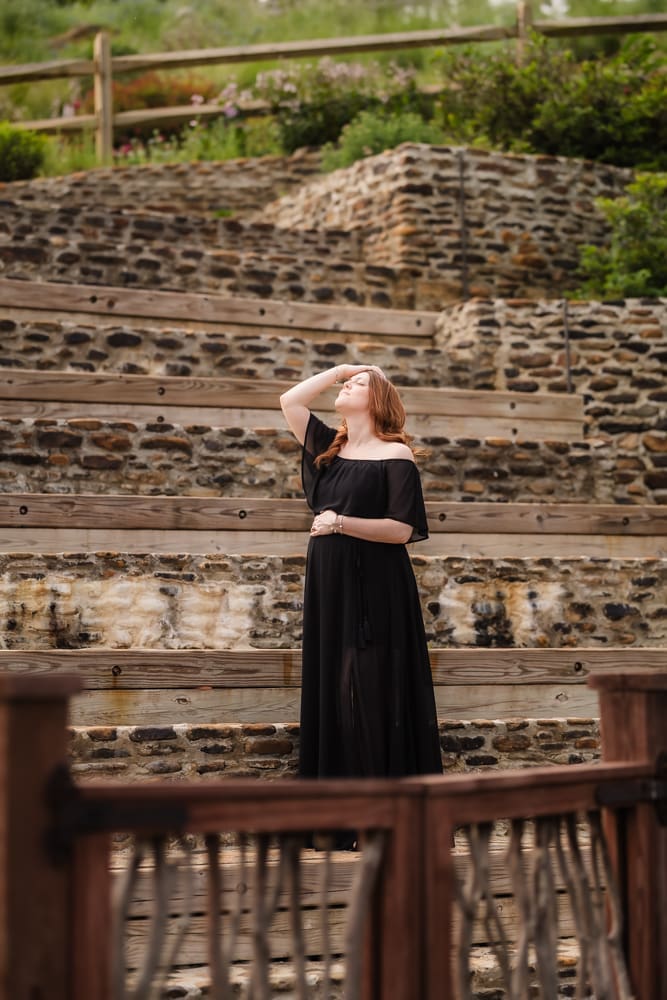 mom on stone steps during fantasy inspired knoxville maternity photography session at ancient lore village