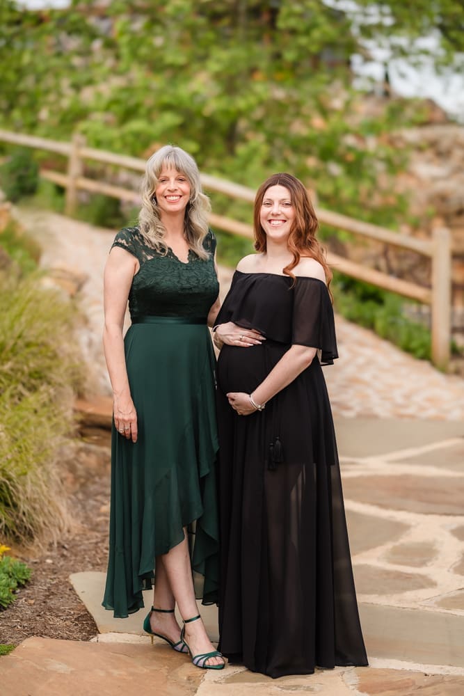 mom and grandma looking at camera during fantasy inspired knoxville maternity photography session at ancient lore village