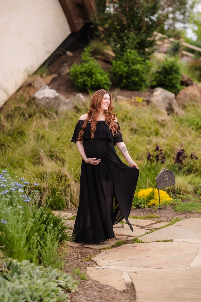 mom twirling in client closet dress during fantasy inspired knoxville maternity photography session at ancient lore village
