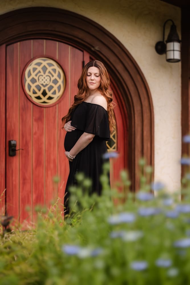 mom holding baby bump during fantasy inspired knoxville maternity photography session at ancient lore village