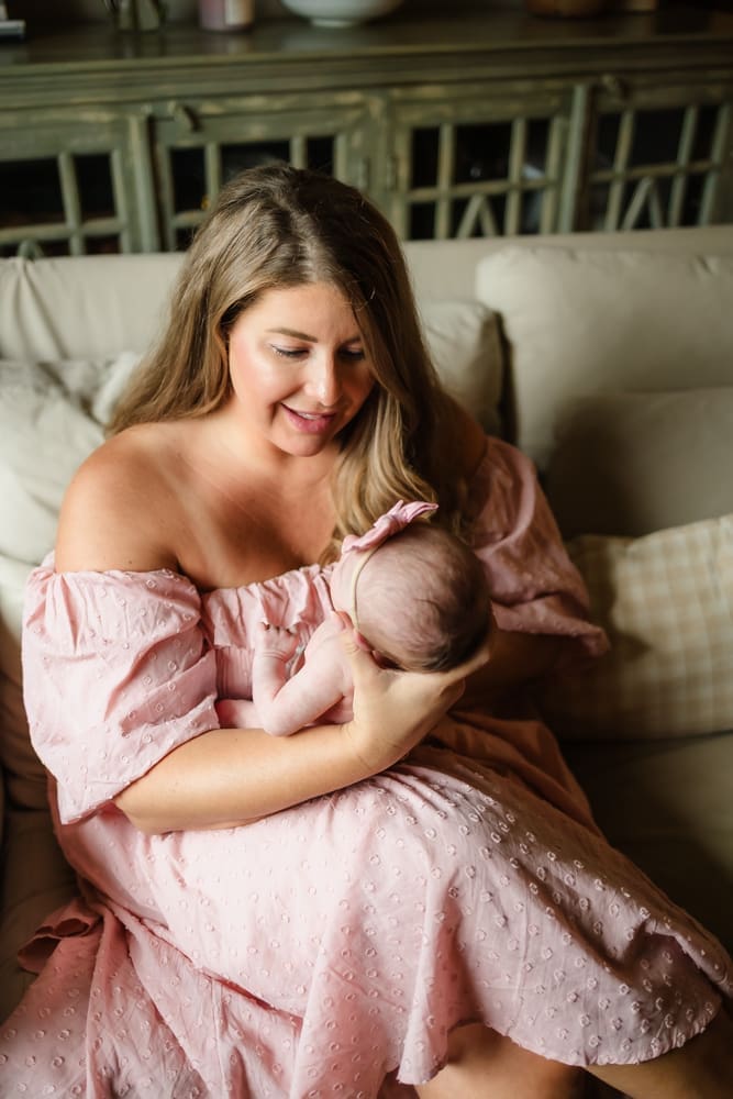 Mother holding her newborn daughter during lifestyle newborn photography in Powell TN