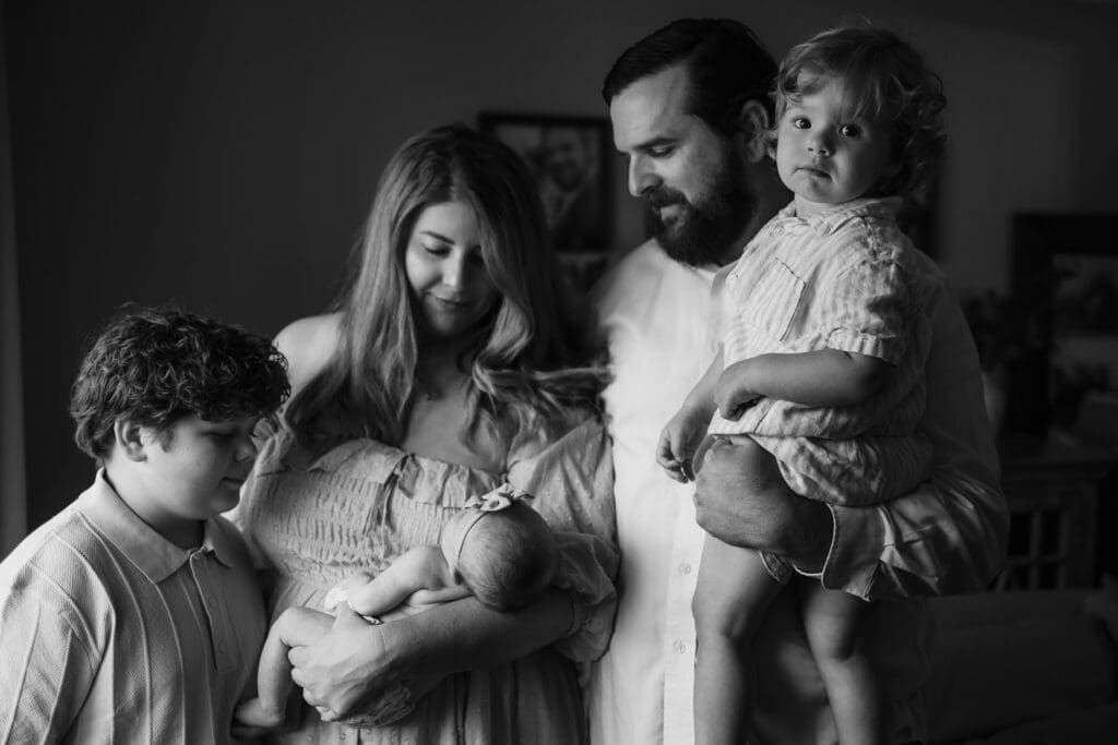 Black and white family portrait with newborn baby during an in-home session in Powell TN