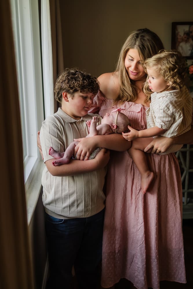 Mother and children together with newborn baby Magnolia during lifestyle newborn photography in Powell TN