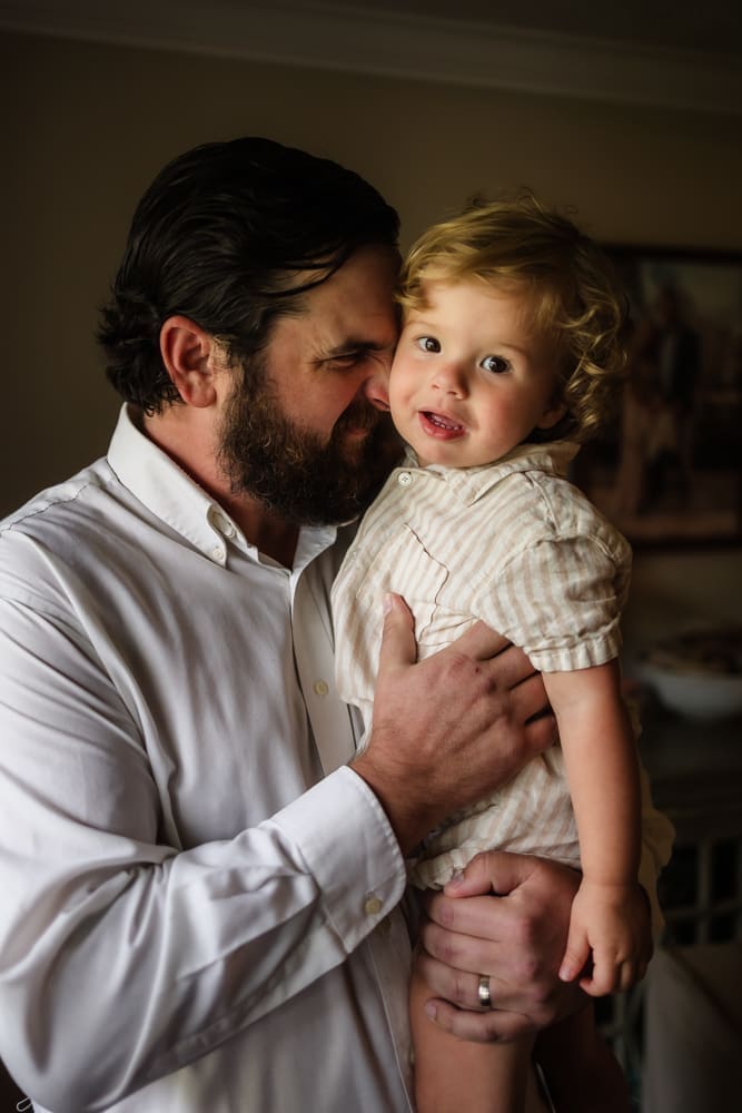 Father holding his young son during a relaxed Powell TN newborn photography session
