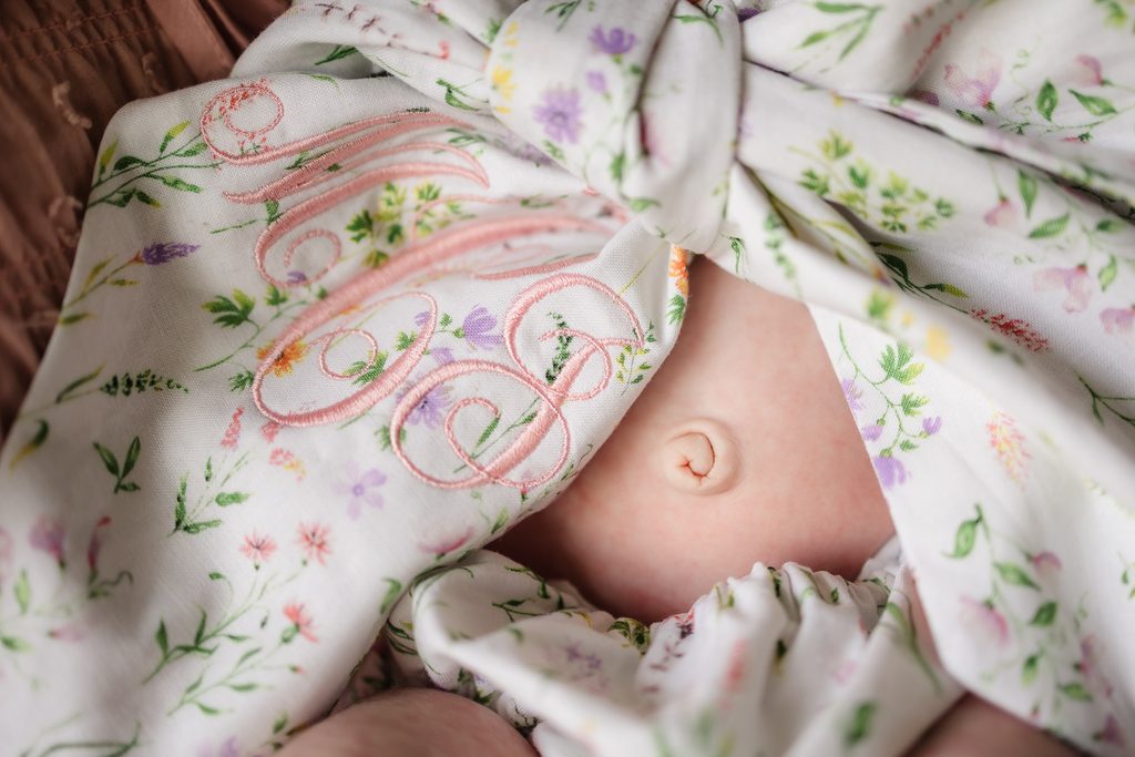 Floral monogrammed newborn bloomers and bow with bellybutton detail photographed during a Powell TN newborn session